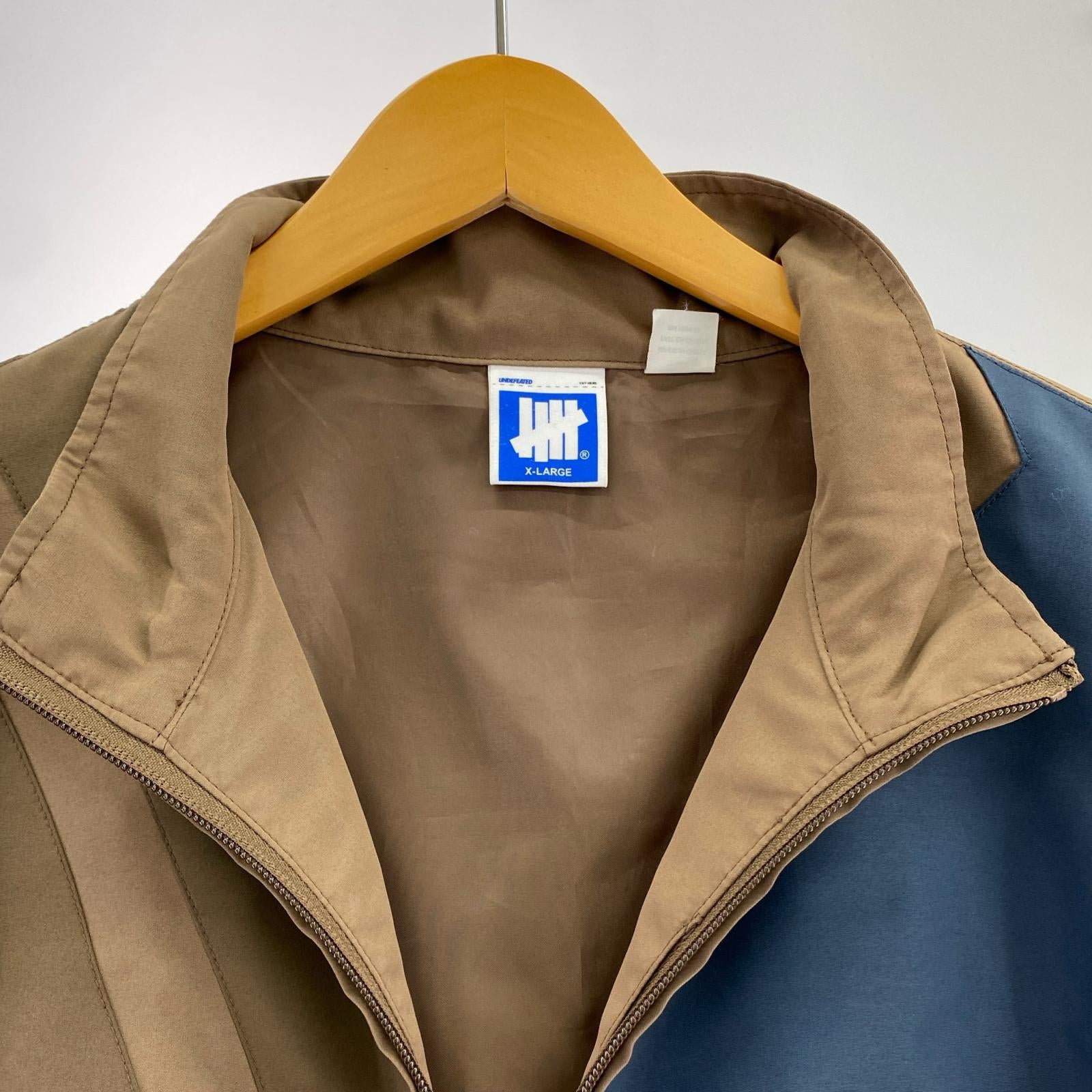 ジャケット UNDEFEATED Patchwork Icon Jacket (XL) ブラウン×マルチカラー LL