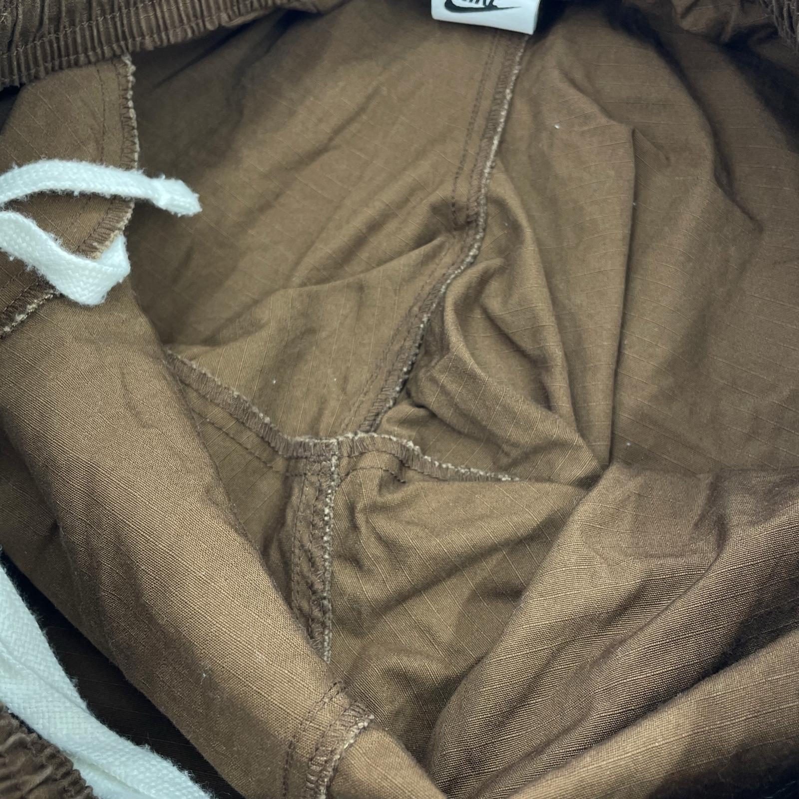 パンツ AS M NK CARGO WVN PANT ブラウン