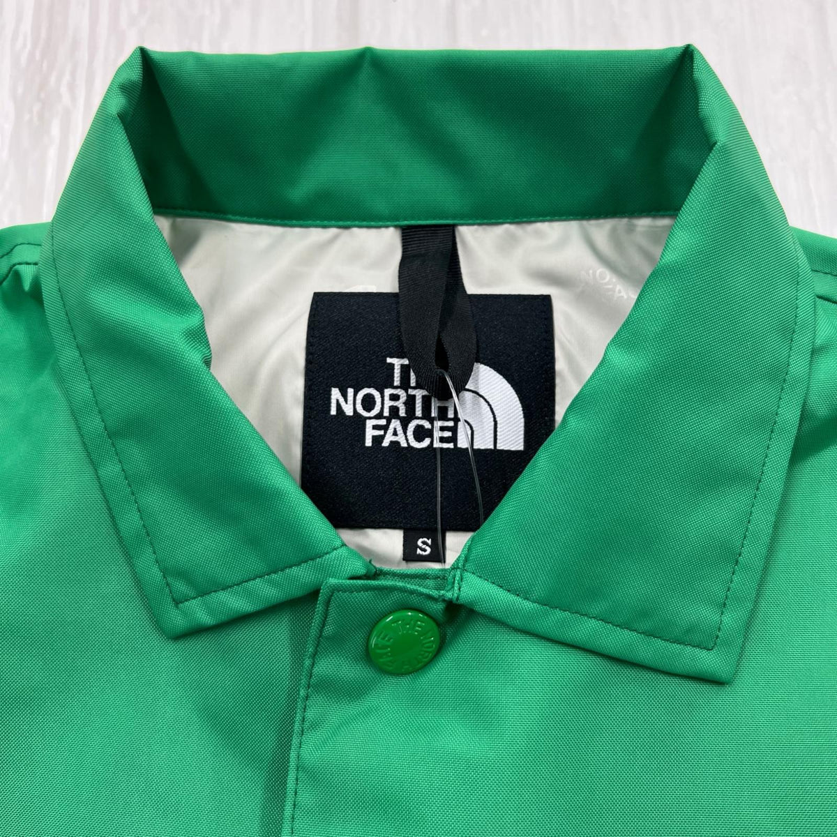 ジャケット THE NORTH FACE NEVER STOP ING The Coach Jacket NP72335 ｵﾌﾟﾃｨｯｸｴﾒﾗﾙﾄﾞ (S) S