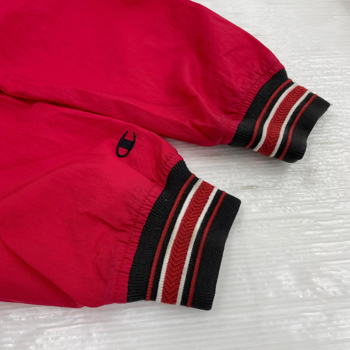 ジャケット Champion ﾊｰﾌｼﾞｯﾌﾟﾅｲﾛﾝｼﾞｬｹｯﾄ ﾚｯﾄﾞ