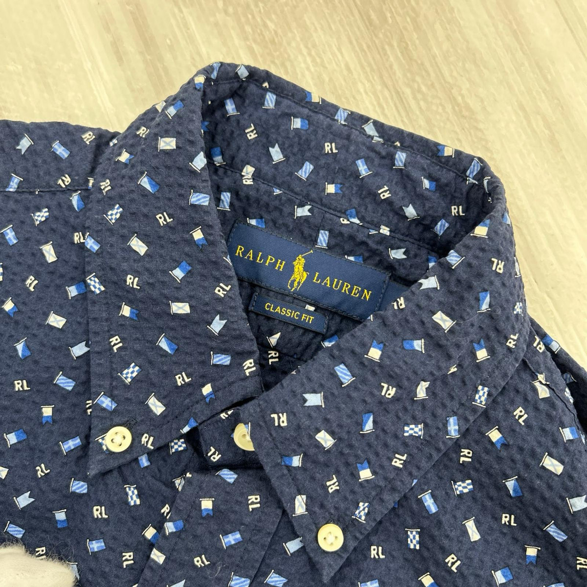 半袖シャツ ｼｱｻｯｶｰ ﾌﾗｯｸﾞ総柄 BLU M M ブルー